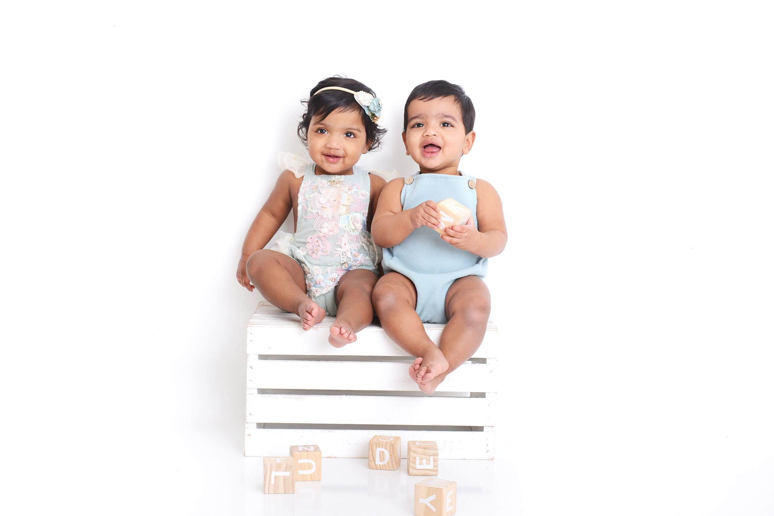 twins smiling at their first birthday photoshoot in houston