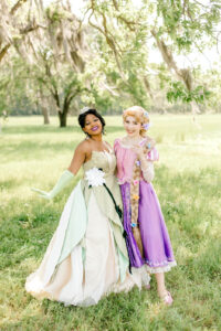 tiana and rapenzul from fairest of all parties posing for a photo