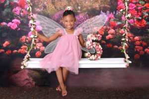 girl smiles at her 5th birthday fairy photoshoot